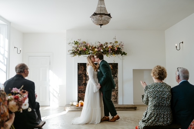 Bridal Couple Kissing In Front Of Fire