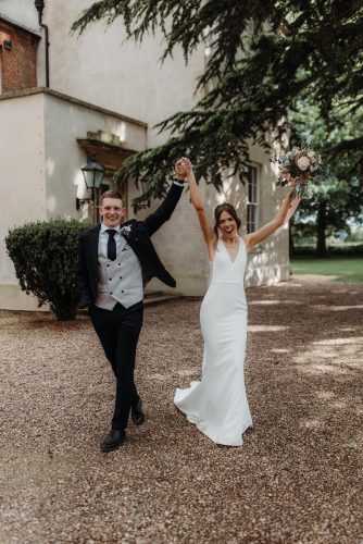 Bride and groom with Arms raised