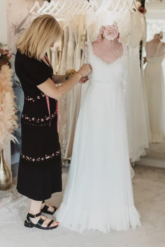 Caroline Adjusting A Wedding Dress