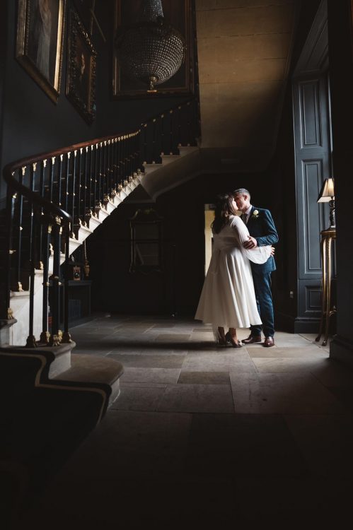 bride and groom by a staircase